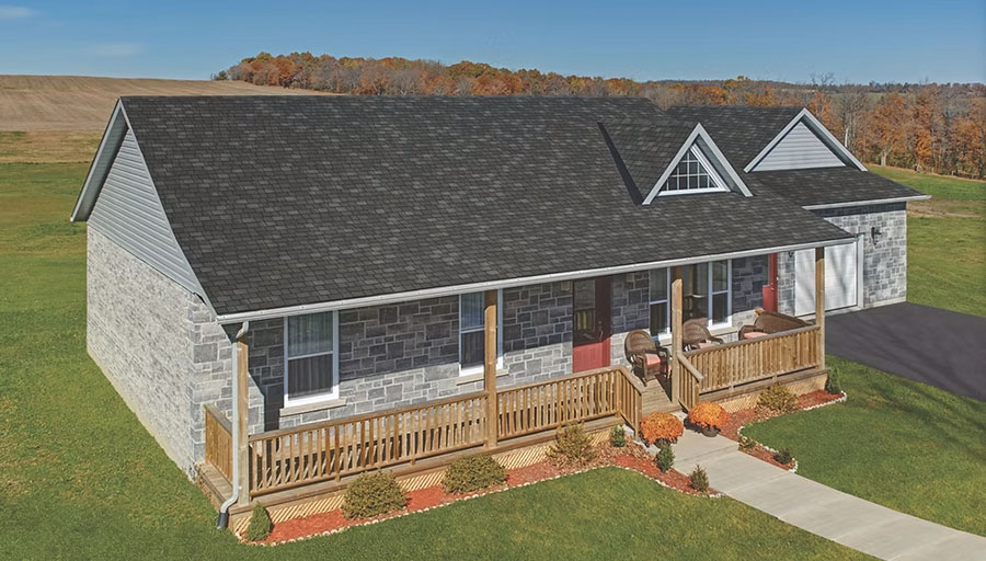 Stone ranch with a new dark asphalt-shingle roof