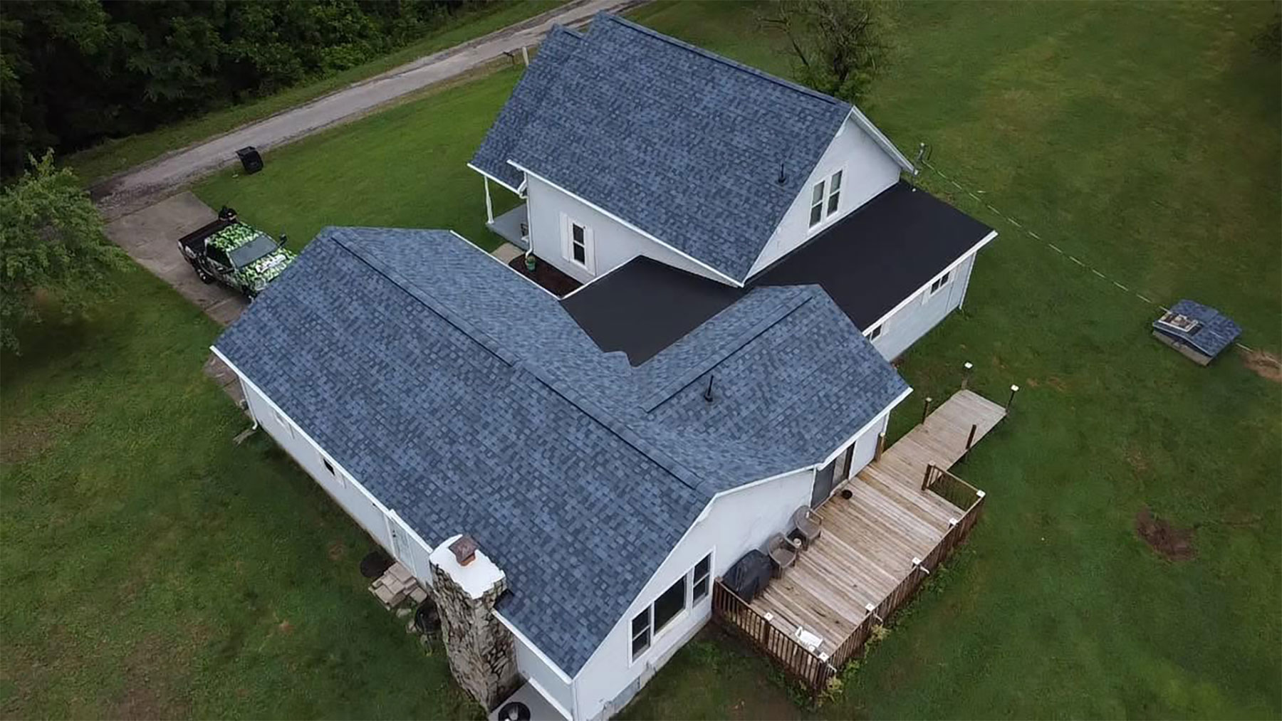 Shingle roof tied into a low-slope membrane on a rural home
